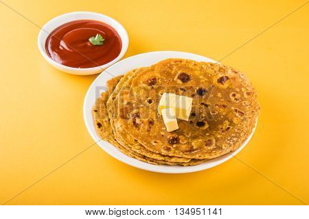 Hot delicious paratha with ghee and tomato sauce