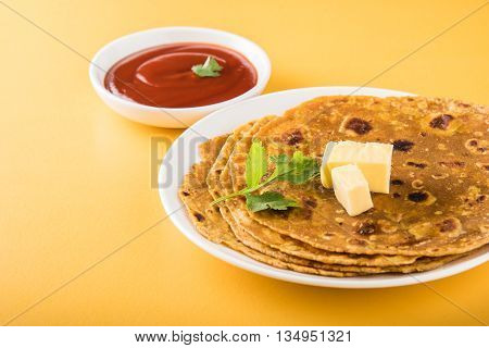 Hot delicious paratha with ghee and tomato sauce