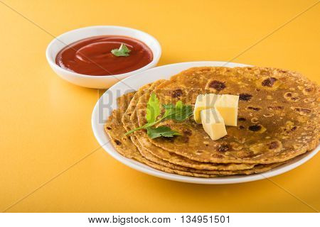 Hot delicious paratha with ghee and tomato sauce