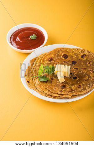 Hot delicious paratha with ghee and tomato sauce