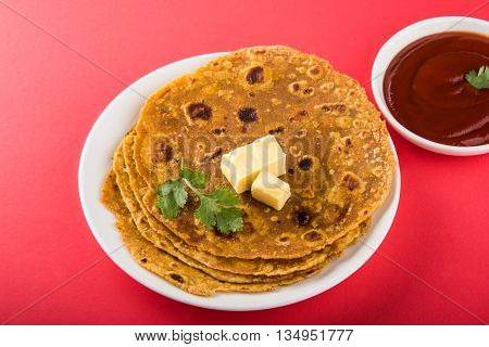 Hot delicious paratha with ghee and tomato sauce