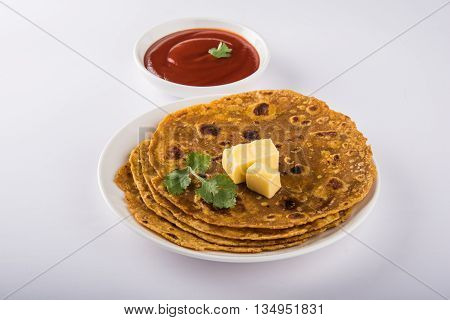 Hot delicious paratha with ghee and tomato sauce