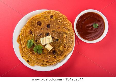 Hot delicious paratha with ghee and tomato sauce