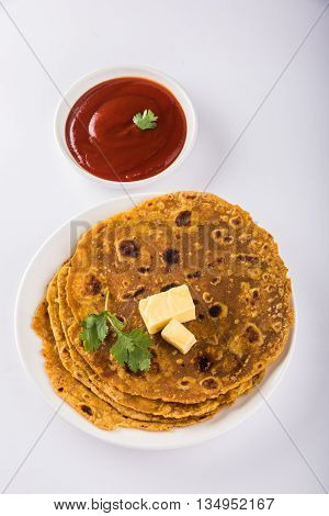 Hot delicious paratha with ghee and tomato sauce