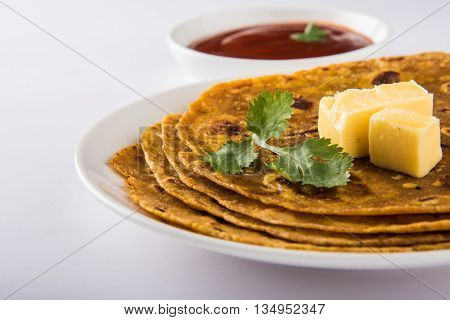 Hot delicious paratha with ghee and tomato sauce