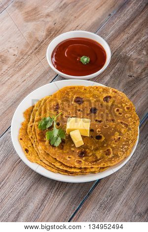 Hot delicious paratha with ghee and tomato sauce