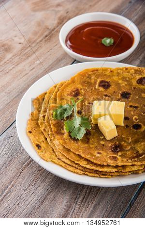 Hot delicious paratha with ghee and tomato sauce