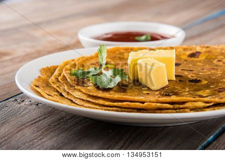 Hot delicious paratha with ghee and tomato sauce