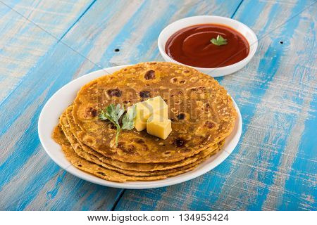 Hot delicious paratha with ghee and tomato sauce