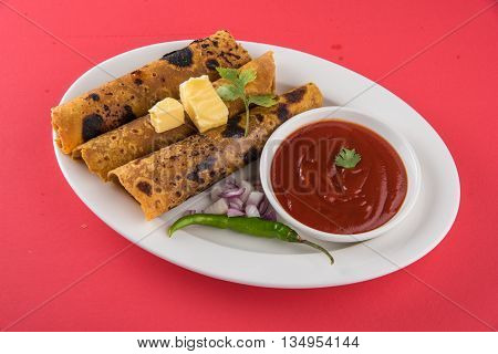 Hot delicious paratha with ghee, green chilly, coriander and tomato sauce. Paratha Rolls. Chapati made using indian spices. Kolkata rolls