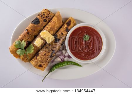 Hot delicious paratha with ghee, green chilly, coriander and tomato sauce. Paratha Rolls. Chapati made using indian spices. Kolkata rolls