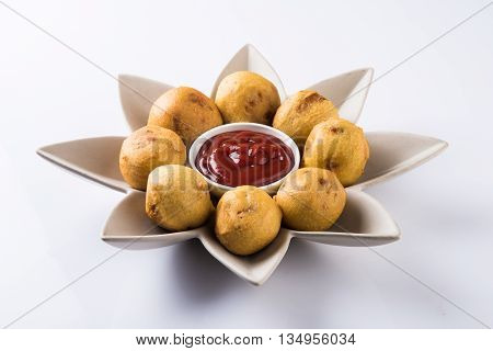 aalu bonda or aalo bonda or batata vada, indian tasty snack tastes great with tea, tea time snack, served with red tomato sauce