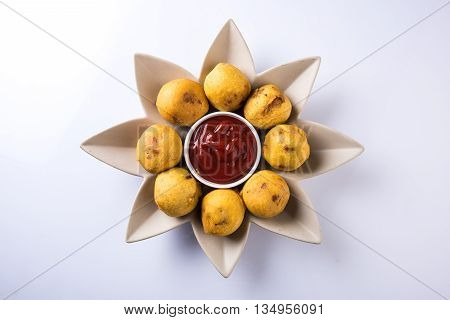 aalu bonda or aalo bonda or batata vada, indian tasty snack tastes great with tea, tea time snack, served with red tomato sauce