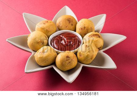 aalu bonda or aalo bonda or batata vada, indian tasty snack tastes great with tea, tea time snack, served with red tomato sauce