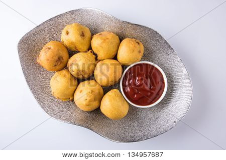 indian snacks also known as urad daal vada or indian pakoda or couth indian pakora or batata vada or aalu bonda or aalu bonde