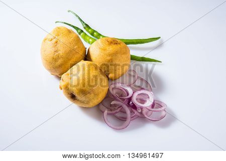 batata vada or aalu bonda or aalu bonde, a tasty indian snacks, served with tomato ketchup or green chilli and onion