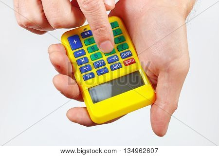 Hands holding a calculator on a white background