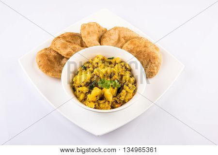 indian semi dry potato spicy recipe also known as aalu bhaji or aalu sabji served with indian puri or poori
