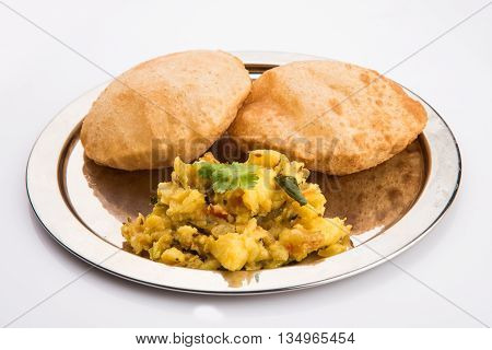 indian semi dry potato spicy recipe also known as aalu bhaji or aalu sabji served with indian puri or poori