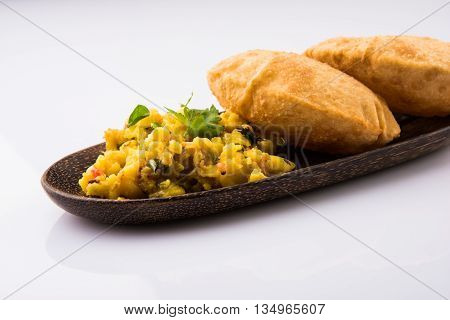 indian semi dry potato spicy recipe also known as aalu bhaji or aalu sabji served with indian puri or poori