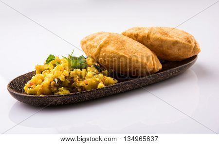 indian semi dry potato spicy recipe also known as aalu bhaji or aalu sabji served with indian puri or poori