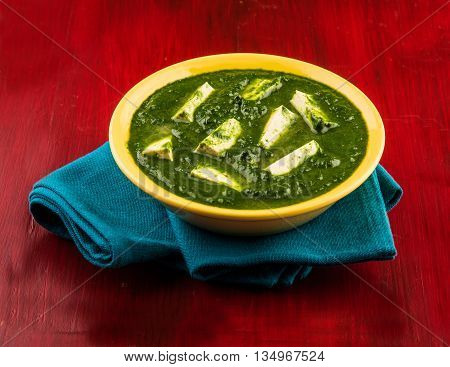 palak paneer served with naan / roti / paratha / chapati / phulka or fulka / indian bread, isolated on white background