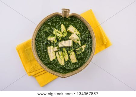 palak paneer served with naan / roti / paratha / chapati / phulka or fulka / indian bread, isolated on white background