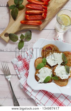 A plate of pancakes with cream cheese and paprika