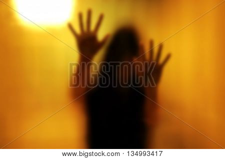 Woman behind the matte glass. Blurry hand and body figure abstraction.
