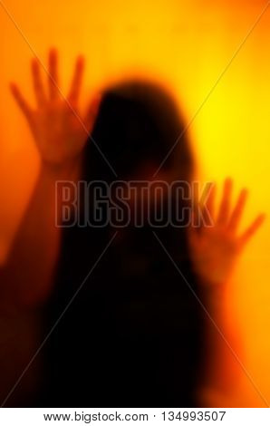 Woman behind the matte glass. Blurry hand and body figure abstraction.