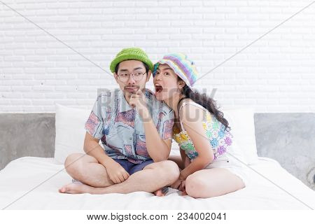 Couple Asian Man And Woman With Woolhat Together Funny Moment On White Bed