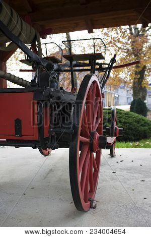 Big,red Wooden Wheel From Old Fire Truck Statue In The Park|autumn