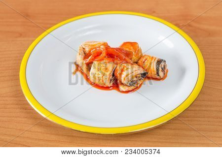 Kashubian-style herring. Herring with onion with tomato oil sauce.