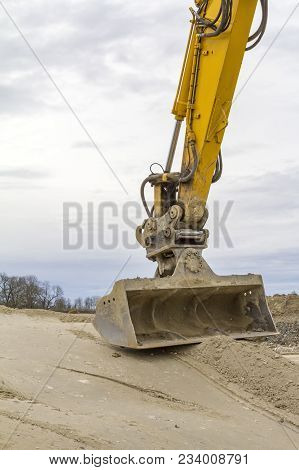Excavator Shovel On Compressed Loamy Ground At A Construction Site