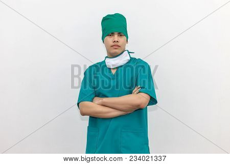 Asian Smart Doctor Wearing Green Uniform And Medical Face Mask. Isolated On White Background.