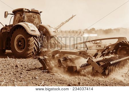 Agriculture. The Tractor Prepares The Ground For Sowing And Cultivation. Agronomy, The Concept Of Fa