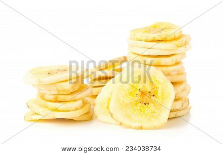 Heap Of Dried Banana Chips Snack Stacked Over White Background