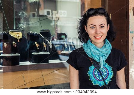 A Cheerful Girl In The Background Of A Showcase With Jewelry. Travels In India