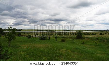 Beautiful Scenery Of The Countryside In The Distance With A Moody Sky.