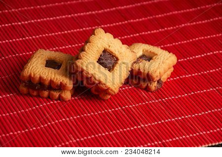 Chocolate Cookies On Gray Plate On Red Table
