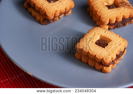 Chocolate Cookies On Gray Plate On Red Table