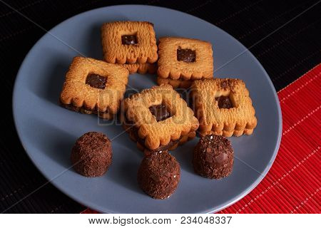 Chocolate Sand Chip Cookies Stacked Up On A Plate, Ready To Be Served.