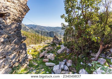Travel And Trekking Concept. Beautiful Mountain Landscape Shot On Sunny Day With Ancient Wall On The
