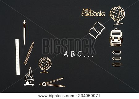 Concept Back To School, Text Abc With School Supplies Chipboard Miniatures Placed On Blackboard