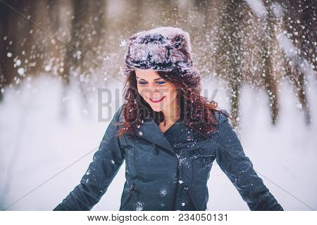 Girl Brunette Against The Background Of The Winter Forest