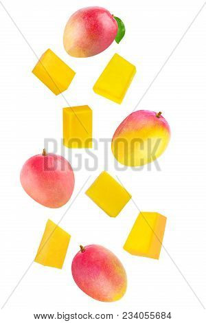 Isolated Flying Fruits. Whole And Cubes Falling Mango Fruit Isolated On White Background With Clippi