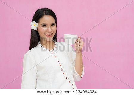 Portrait Beautiful Asian Girl In Traditional Thai Dress And Holding Coffee Cup Isolated On Pink Back