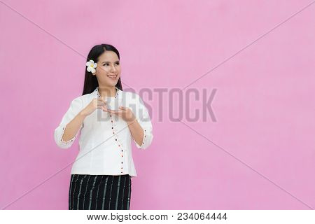Portrait Beautiful Asian Girl In Traditional Thai Dress And Holding Coffee Cup Isolated On Pink Back