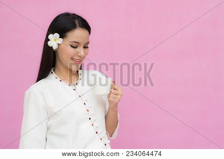 Portrait Beautiful Asian Girl In Traditional Thai Dress And Holding Coffee Cup Isolated On Pink Back