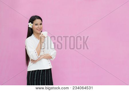 Portrait Beautiful Asian Girl In Traditional Thai Dress And Holding Coffee Cup Isolated On Pink Back